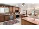 Well-appointed kitchen featuring wood cabinetry, stainless steel appliances, and a convenient center island at 8752 E Range Rider Trl, Mesa, AZ 85207