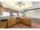 Sunlit kitchen featuring wood cabinets, tile floors, and a scenic view at 8752 E Range Rider Trl, Mesa, AZ 85207