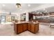 Open kitchen and living area highlighting natural light and custom woodworking throughout the room at 8752 E Range Rider Trl, Mesa, AZ 85207