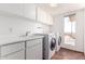 Laundry room with a white countertop, sink, modern washer and dryer, and a window with neighborhood views at 8752 E Range Rider Trl, Mesa, AZ 85207