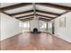 Bright living room with beamed ceilings, fireplace, and sliding doors to a pool at 8752 E Range Rider Trl, Mesa, AZ 85207
