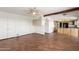 Open-concept space connecting to the kitchen, features tile flooring and ample closet space at 8752 E Range Rider Trl, Mesa, AZ 85207