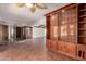 Living room features a large built-in shelving unit and terra cotta tile floors at 8752 E Range Rider Trl, Mesa, AZ 85207