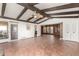 Open living space with exposed beam ceiling, and access to the kitchen and patio at 8752 E Range Rider Trl, Mesa, AZ 85207