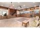 Living room showcasing wooden wall paneling, desert mural art, and convenient staircase access at 8752 E Range Rider Trl, Mesa, AZ 85207
