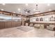 Expansive living room featuring unique wood paneling, built-in shelving, and desert-themed decor at 8752 E Range Rider Trl, Mesa, AZ 85207
