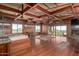 Large main bedroom with exposed beam ceilings, a fireplace, and sliding doors to a balcony at 8752 E Range Rider Trl, Mesa, AZ 85207