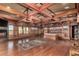 Expansive main bedroom with custom wood beams, built-in shelving, and a cozy fireplace at 8752 E Range Rider Trl, Mesa, AZ 85207
