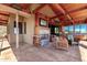 Covered patio features a fireplace, TV, seating, outdoor kitchen, and stunning desert views at 8752 E Range Rider Trl, Mesa, AZ 85207