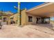 Spacious covered patio area with desert landscaping, a large cactus, and views of the outdoor dining space at 8752 E Range Rider Trl, Mesa, AZ 85207