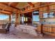 Open patio with natural stone steps, wood accents, and an outdoor kitchen for entertaining guests at 8752 E Range Rider Trl, Mesa, AZ 85207