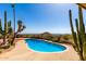 Beautiful backyard pool featuring desert landscaping and stunning views of the surrounding area at 8752 E Range Rider Trl, Mesa, AZ 85207