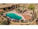 Aerial view of a large in-ground pool surrounded by desert landscaping, cacti and desert trees at 8752 E Range Rider Trl, Mesa, AZ 85207