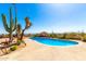 Backyard pool offers a serene retreat with desert landscaping and scenic views at 8752 E Range Rider Trl, Mesa, AZ 85207