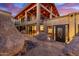 Desert home with exposed wood architectural beams, custom door, and unique landscaping at 8752 E Range Rider Trl, Mesa, AZ 85207