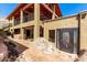 Desert home under construction with custom door, wood beam second story and mountain views at 8752 E Range Rider Trl, Mesa, AZ 85207