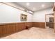 Inviting room with wood paneling, mini-split system, art and a small wood stool at 8752 E Range Rider Trl, Mesa, AZ 85207