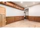 Open room featuring display shelf, wood paneling, outlets, and a recessed light at 8752 E Range Rider Trl, Mesa, AZ 85207