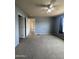 Spacious bedroom features neutral carpet, light grey walls, ceiling fan, and natural light at 8832 E Pueblo Ave # 20, Mesa, AZ 85208