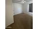 This cozy bedroom features neutral walls, plush carpet, and ample natural light from the window at 8832 E Pueblo Ave # 20, Mesa, AZ 85208