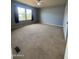 This bedroom features a ceiling fan and carpeted floors with natural light from the window at 8832 E Pueblo Ave # 20, Mesa, AZ 85208