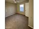View of the carpeted bedroom showcasing a ceiling fan, neutral walls, and natural light at 8832 E Pueblo Ave # 20, Mesa, AZ 85208