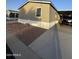 View of a light tan single-story home, with easy-to-maintain gravel landscaping and a covered parking space at 8832 E Pueblo Ave # 20, Mesa, AZ 85208
