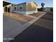 View of a light tan single-story home, with easy-to-maintain gravel landscaping and concrete walkway at 8832 E Pueblo Ave # 20, Mesa, AZ 85208