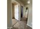 Hallway showcasing the transition between tile flooring and carpeted floors at 8832 E Pueblo Ave # 20, Mesa, AZ 85208
