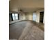 View of the carpeted living room showcasing a ceiling fan, neutral walls, and natural light at 8832 E Pueblo Ave # 20, Mesa, AZ 85208