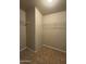 This walk-in closet features tile flooring with multiple metal storage racks at 8832 E Pueblo Ave # 20, Mesa, AZ 85208