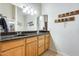 Bathroom vanity featuring black granite countertop and mason jar shelving at 8942 W Peck Dr, Glendale, AZ 85305