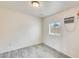 Standard bedroom with hardwood floors, window, and AC unit at 8942 W Peck Dr, Glendale, AZ 85305