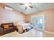 Primary bedroom featuring a ceiling fan, sliding doors, and a leather couch at 8942 W Peck Dr, Glendale, AZ 85305