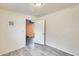 Simple bedroom featuring light gray wood floors with a doorway to another room at 8942 W Peck Dr, Glendale, AZ 85305