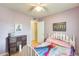 Angle of the bedroom featuring a white bed, light purple walls, and a dresser at 8942 W Peck Dr, Glendale, AZ 85305