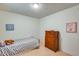 Bright bedroom features hardwood floors, neutral wall decor, and a comfortable twin bed at 8942 W Peck Dr, Glendale, AZ 85305