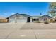 Charming single-story home with a well-maintained front yard and spacious three-car garage at 8942 W Peck Dr, Glendale, AZ 85305