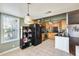 Spacious kitchen featuring wooden cabinetry, black appliances, black countertops, and tile flooring at 8942 W Peck Dr, Glendale, AZ 85305