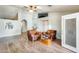 Bright living room with high ceilings, wood-look laminate flooring, and leather armchairs at 8942 W Peck Dr, Glendale, AZ 85305