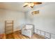 View of the living room with gray walls, a grey chair, shelves, and a ladder at 8942 W Peck Dr, Glendale, AZ 85305