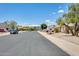 Neighborhood street view showcasing well-maintained homes and a stadium in the distance at 8942 W Peck Dr, Glendale, AZ 85305