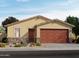 Inviting one-story home featuring a two-car garage, stone accents, and a well-manicured front yard at 9103 N 173Rd Ln, Waddell, AZ 85355