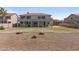 Expansive backyard with a covered patio, green lawn, and desert landscaping at 9548 W Keyser Dr, Peoria, AZ 85383