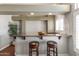 Stylish bar area with granite countertops, wooden stools, and ample lighting, perfect for entertaining guests at 9548 W Keyser Dr, Peoria, AZ 85383