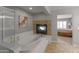 Luxurious bathroom with a soaking tub, fireplace, and a separate shower area at 9548 W Keyser Dr, Peoria, AZ 85383