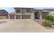 Charming home with a three car garage and a well-manicured lawn on a sunny day at 9548 W Keyser Dr, Peoria, AZ 85383
