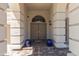 Inviting front entrance featuring double doors, decorative columns, and elegant lighting fixtures at 9548 W Keyser Dr, Peoria, AZ 85383