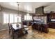 Charming kitchen with a wooden table next to the island and natural light from the windows at 9548 W Keyser Dr, Peoria, AZ 85383