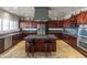 Gourmet kitchen featuring a large island with seating, stainless steel appliances, and ample cabinet space at 9548 W Keyser Dr, Peoria, AZ 85383